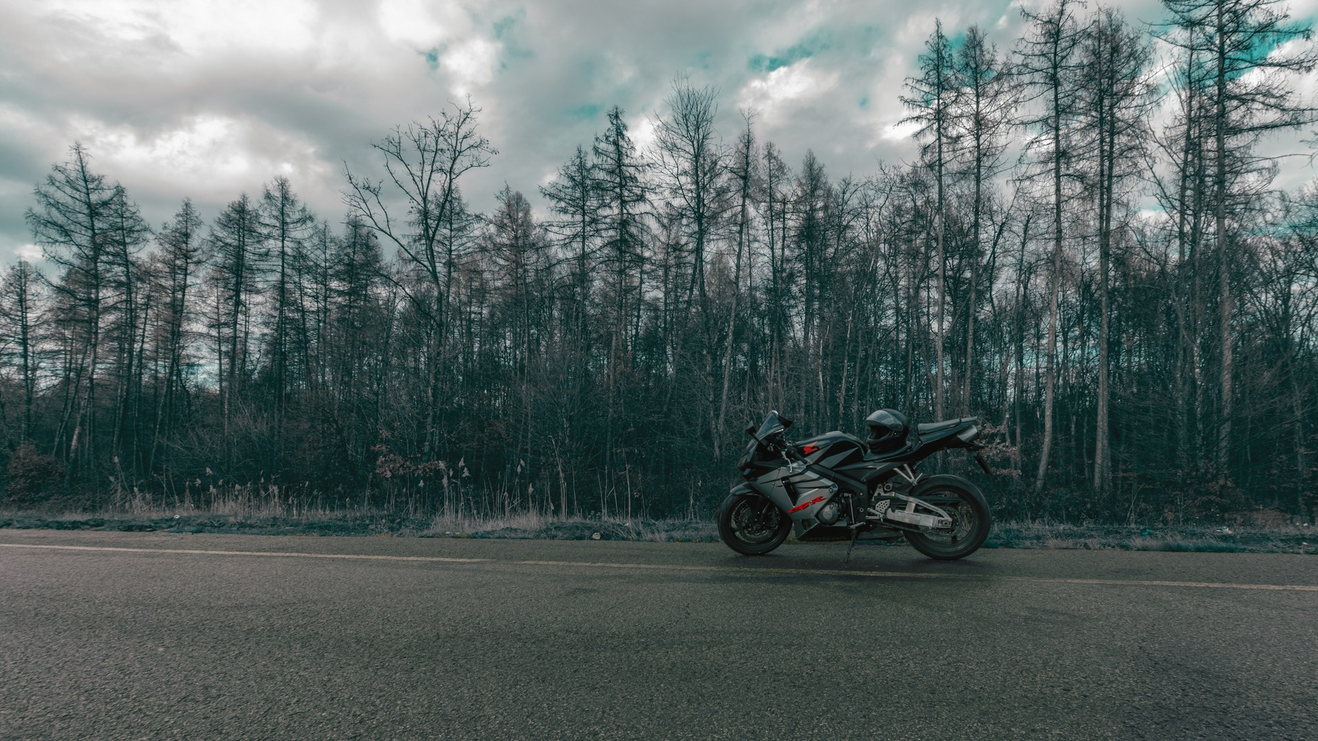 Motorcyclist riding in cold weather gear on a Roseville road in winter