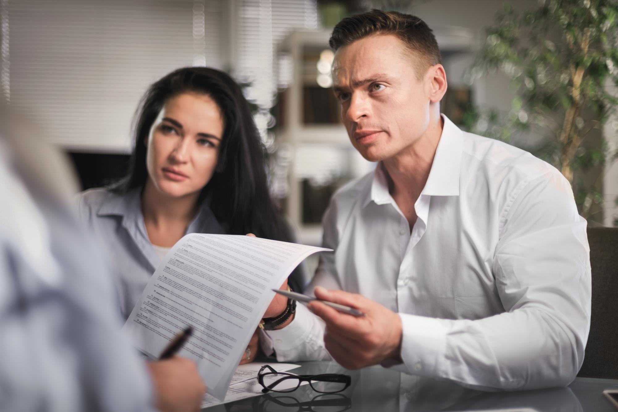 Clients reviewing a denied insurance claim letter with their attorney