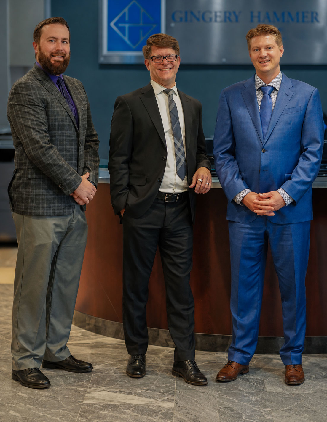 Gingery Hammer & Associates personal injury attorneys standing in their office lobby