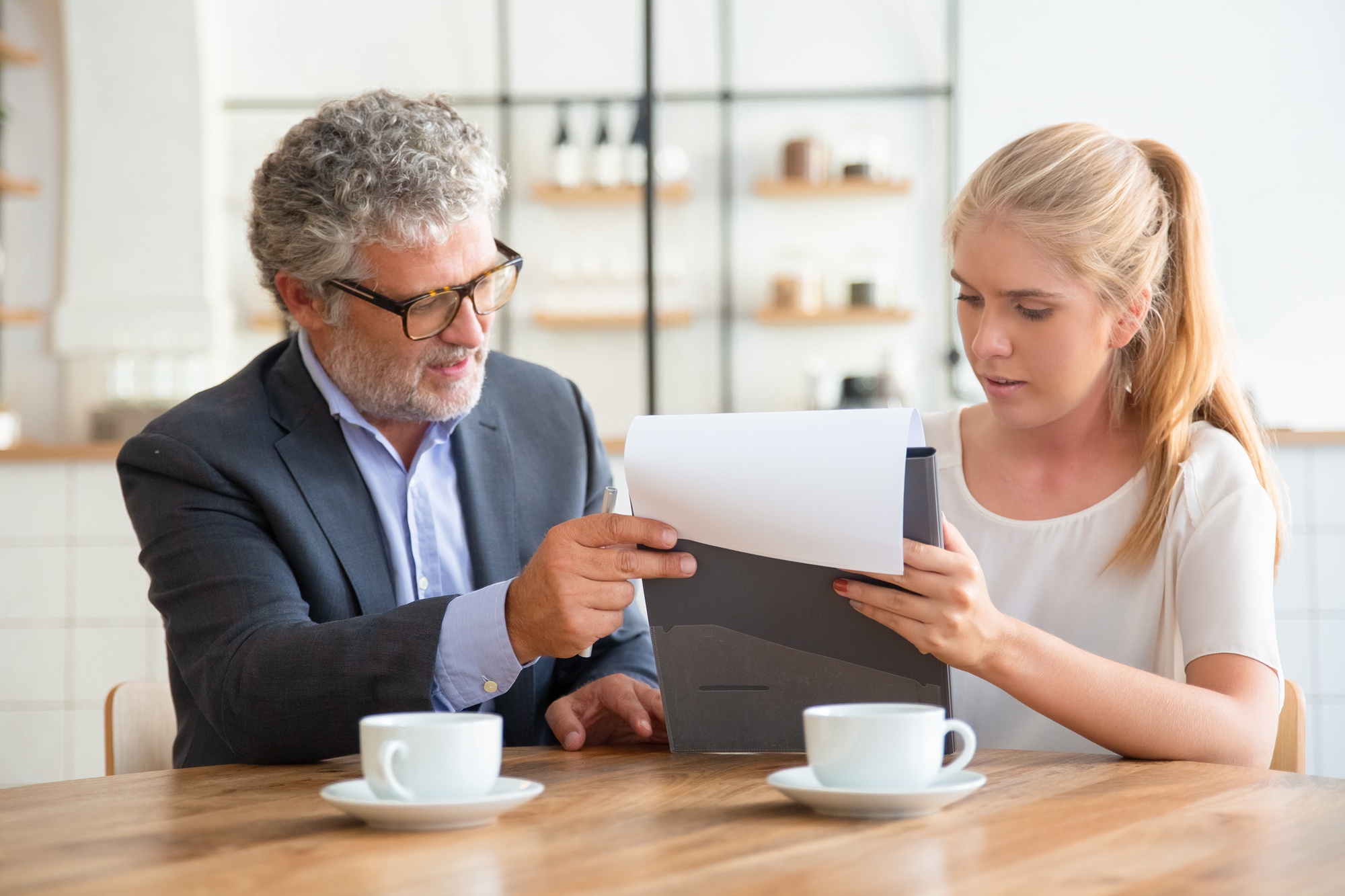 Legal advisor reviewing an insurance denial letter with a client